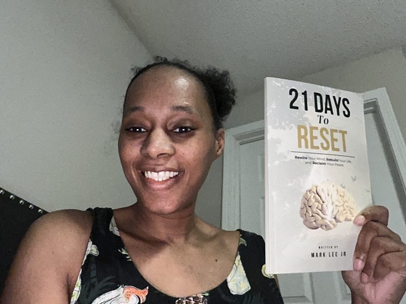 Crystal holding her signed copy of 21 Days to Reset